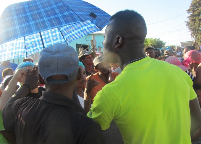 Photo of two men and a crowd confronting each other