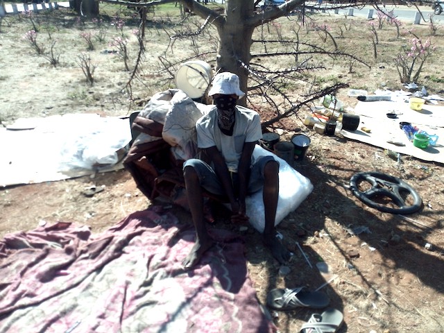 Photo of a young man sitting on the ground