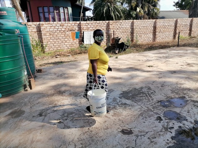 Photo of a woman with a bucket