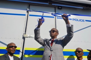 Photo of a man cutting a ribbon