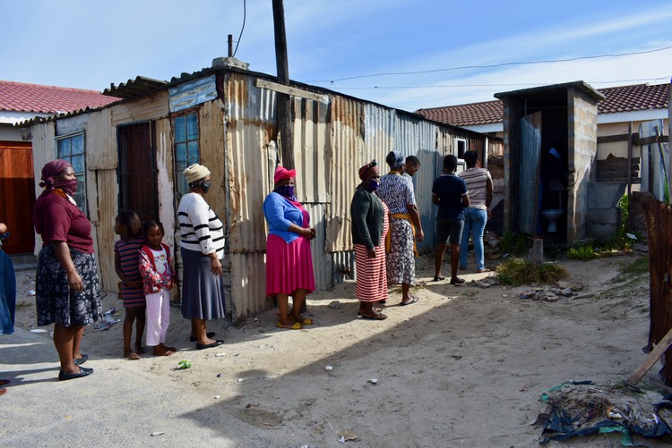 Photo of a queue of people outside a toilet