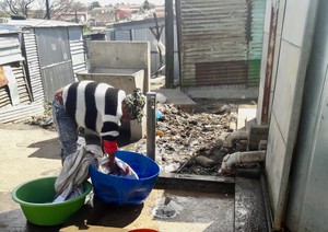 Photo of a woman washing a blanket