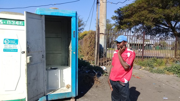 Photo of man next to toilet