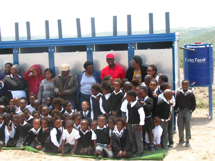 Photo of school children in front of toilet block