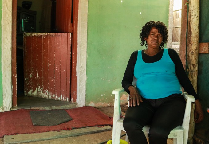 Photo of woman in front of her house