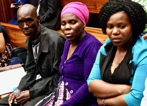 Photo of three people in court