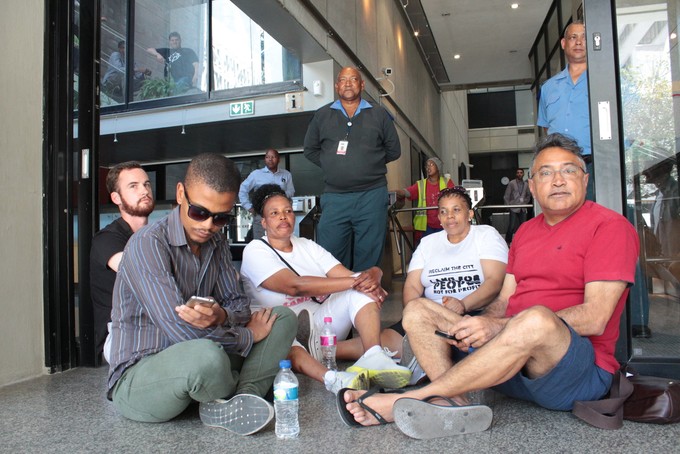 Photo of activists blocking access to building