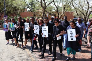 Photo of marchers with placards