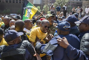 Photo of protesters and police standing off