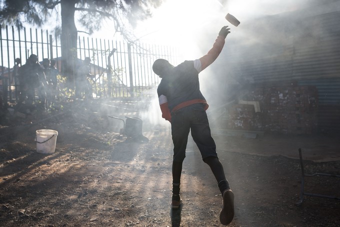 Photo of a man throwing a rock