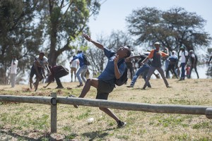 Photo of protester throwing a stone