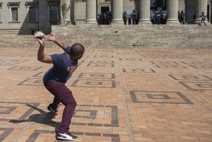 Photo of student protester throwing rock