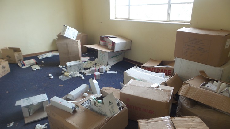 Photo of files and pills all over office floor