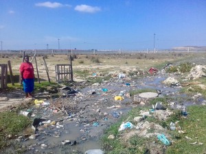 photo of a woman outsdie her house