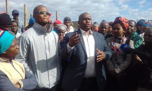 Photo of two men addressing crowd