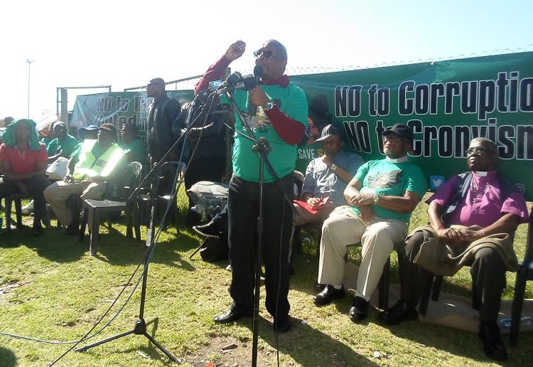 Photo of man addressing crowd