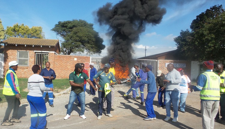 Photo of men around a fire