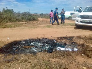 Photo of police at a piece of scorched earth