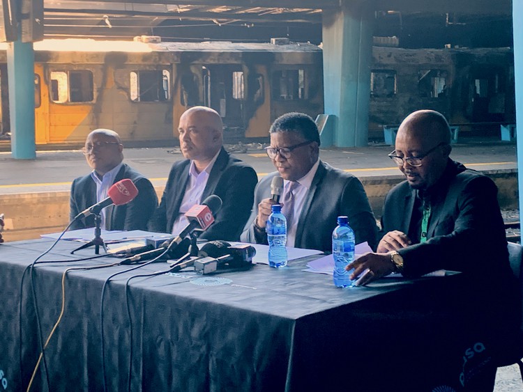 Photo of four men at a table