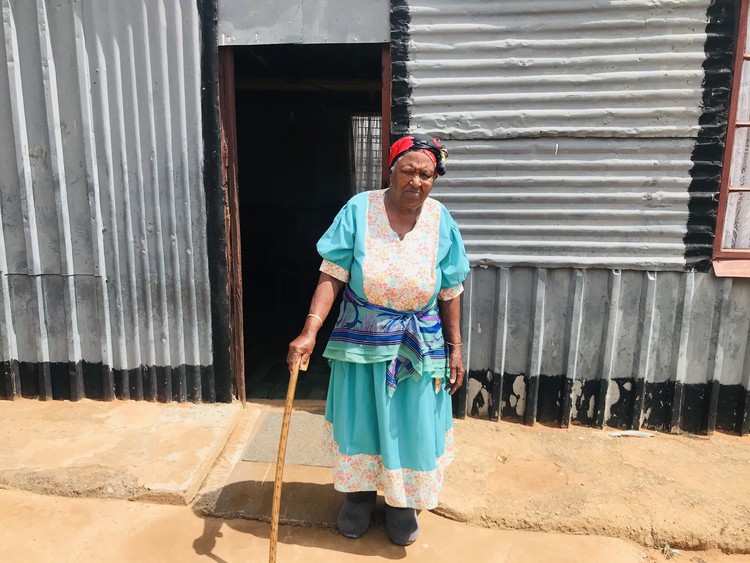 Photo of Johanna Parsons in front of her shack