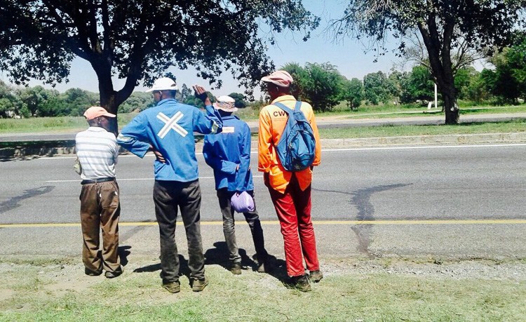 Photo of men on the side of a road