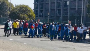 Photo of people marching in street