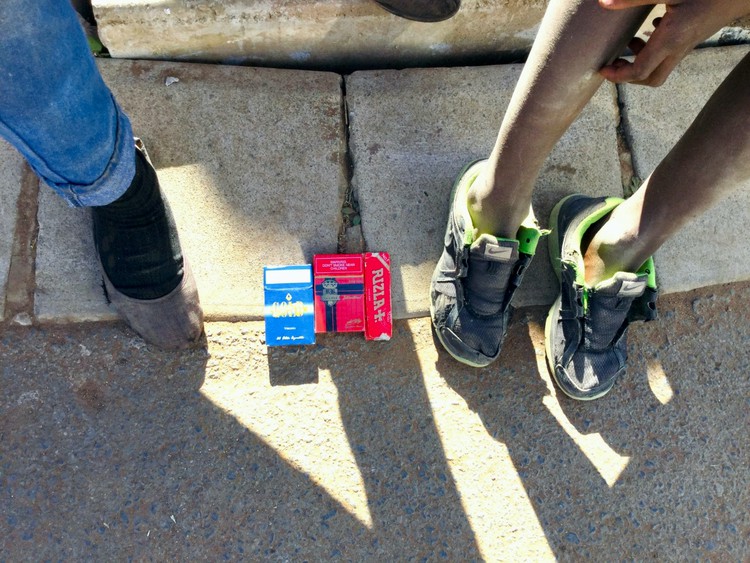 Photo of cigarette packs on the pavement