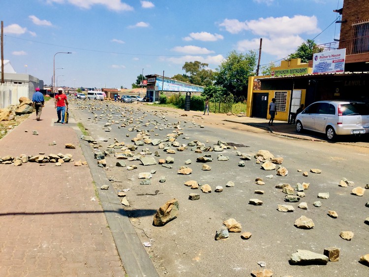 Photo of a street strewn with rocks