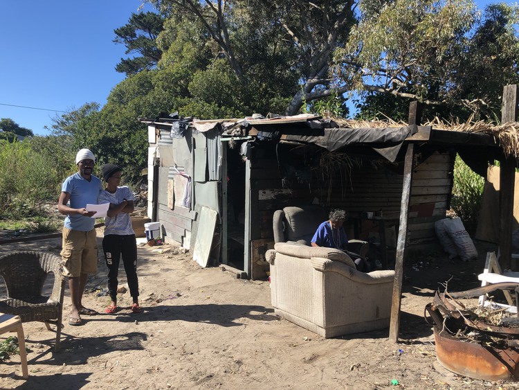 Photo of people outside shack