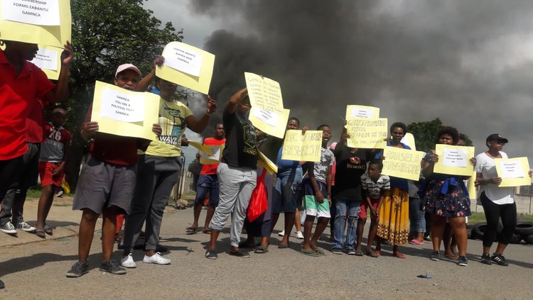 Photo of potesters holding up posters