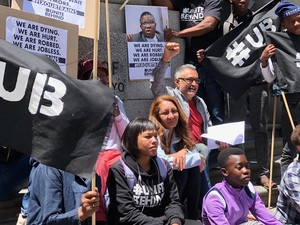 Photo of people sitting on court steps