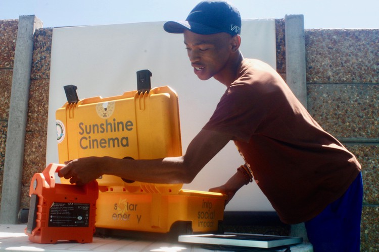 Photo of a man with a screen and projecter