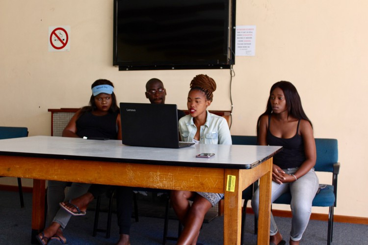 Photo of four students at a desk