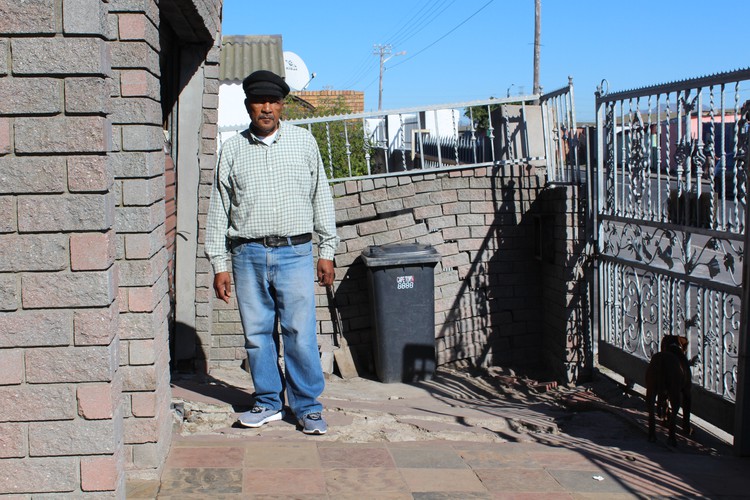 Photo of man in front of breaking wall