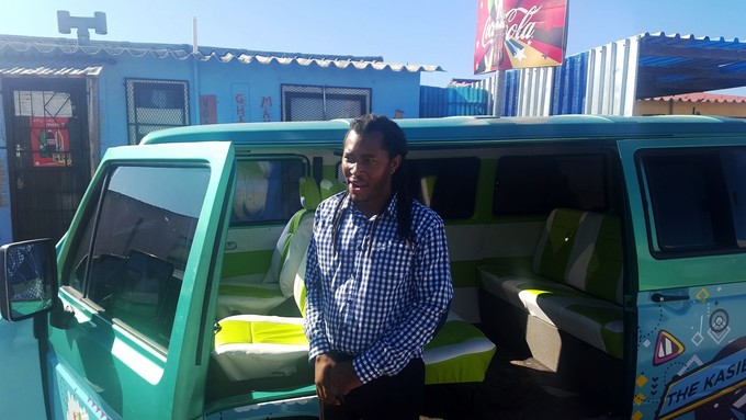 Picture of a man in front of a vehicle