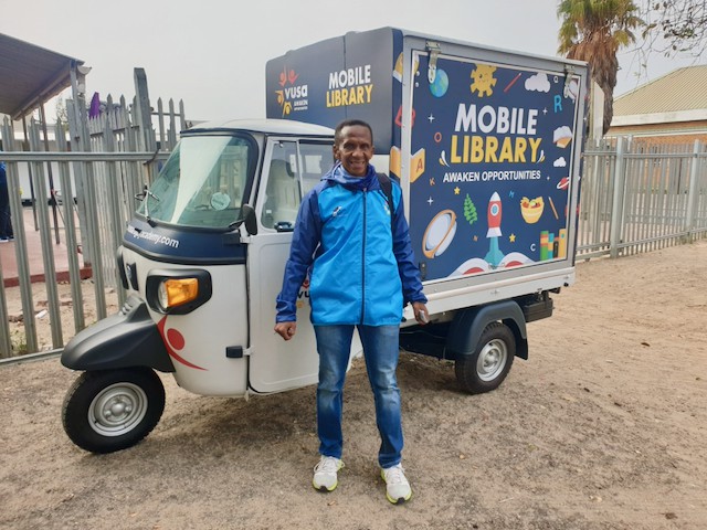 Photo of a tuk tuk and a man