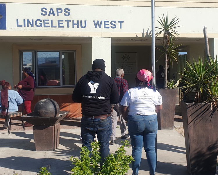 Photo of people outside a police station