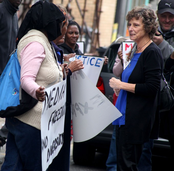 Photo of placard saying Sekunjalo Hands Off Journalists