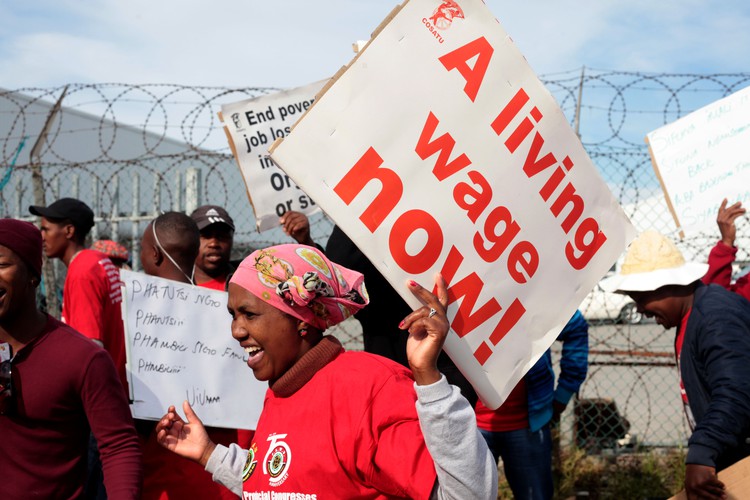 Photo of woman protesting for higher wages