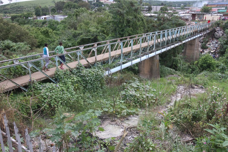 Photo of bridge and dirty river