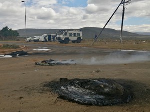 Photo of protest debris and police vehicles