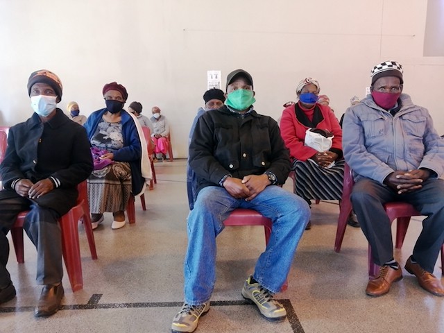 Photo of people sitting on chairs