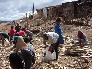 Photo of people picking up wood