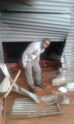 Photo of man with broken shack