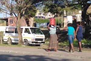 Photo of people carrying water