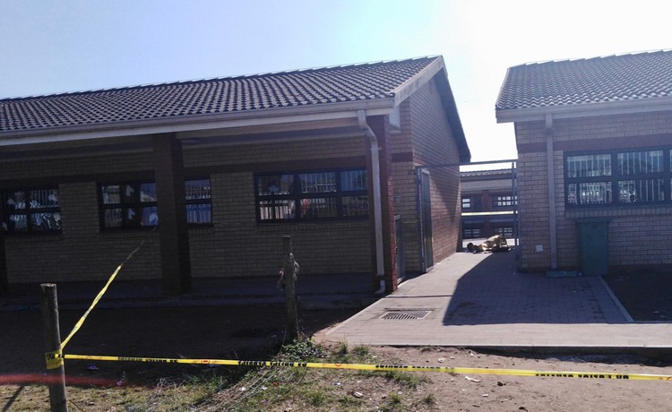 Photo of two school buildings and a body