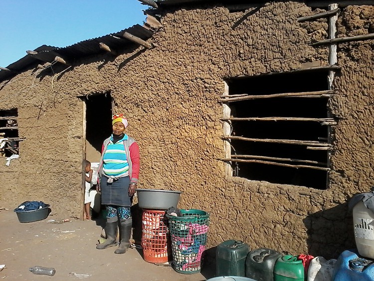 Photo of a woman outside her house