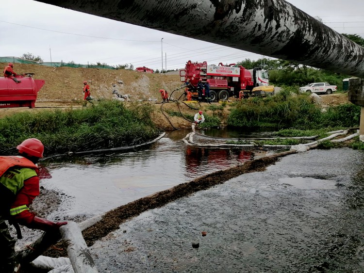 Photo of a pipeline and workers