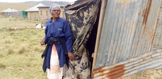 Photo of a woman next to a small sahck