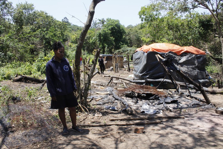 Photo of woman and burned house